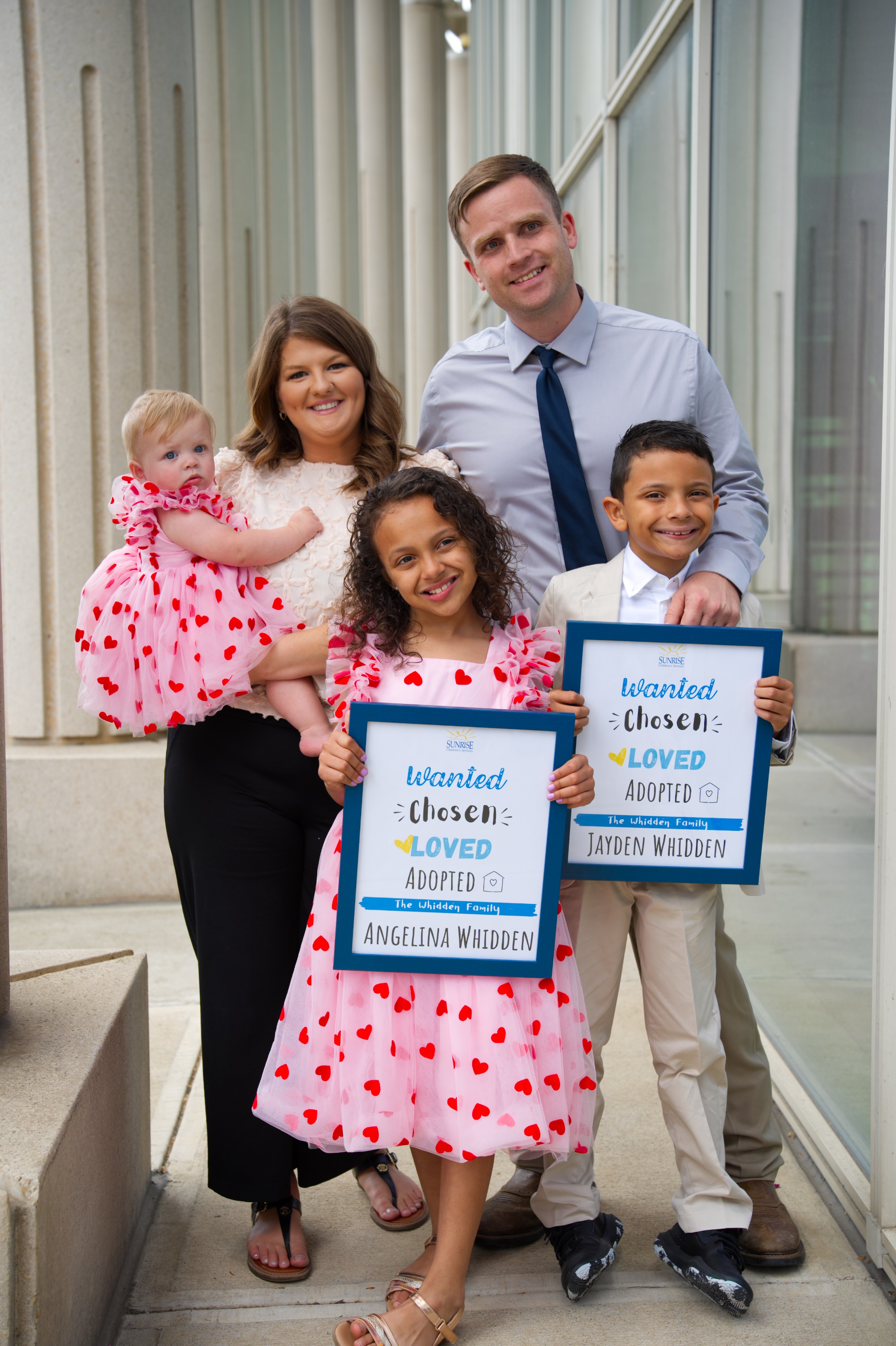 A family celebrating a Sunrise adoption