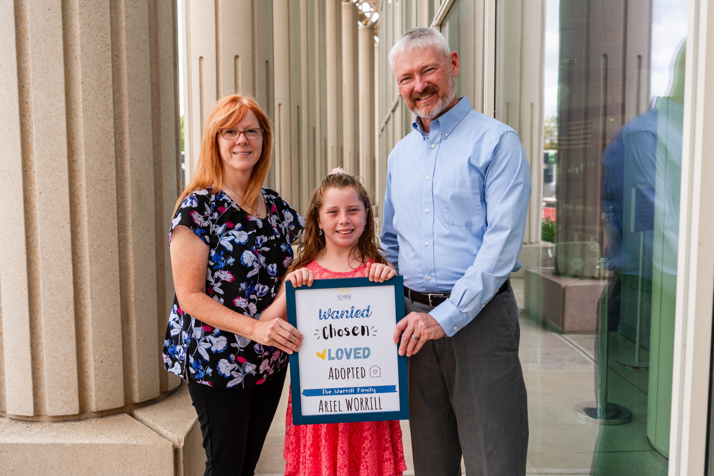 A family smiling after a Sunrise adoption