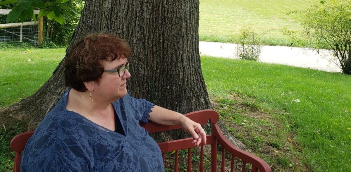 Judy Singleton seated outdoors at Solid Rock Children’s Ranch